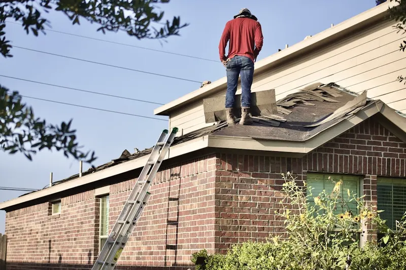 Professional roofer working on a residential roof in Bloomington Ferry